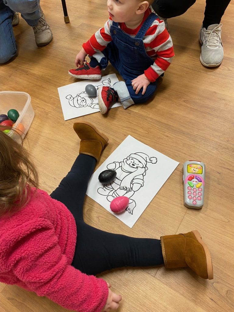 Two children coloring during Tiny Tales.