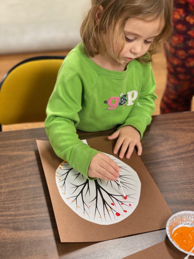 Child doing a craft during story time.