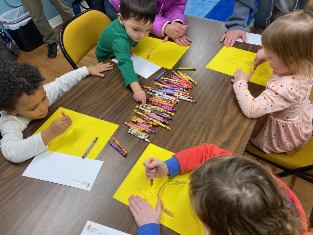 Children coloring during story time